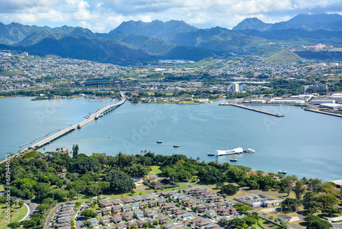 Aerial view of the USS Arizona war memorial with the Aloha Stadium and Koolau mountains in the backround at Pearl Harbor in Honolulu on Oahu, Hawaii