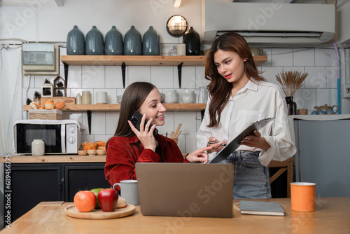 Two business women work together at home office Share your opinions about working online.