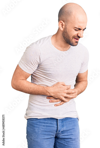 Young handsome man wearing casual t shirt with hand on stomach because nausea, painful disease feeling unwell. ache concept.