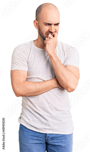 Young handsome man wearing casual t shirt looking stressed and nervous with hands on mouth biting nails. anxiety problem.
