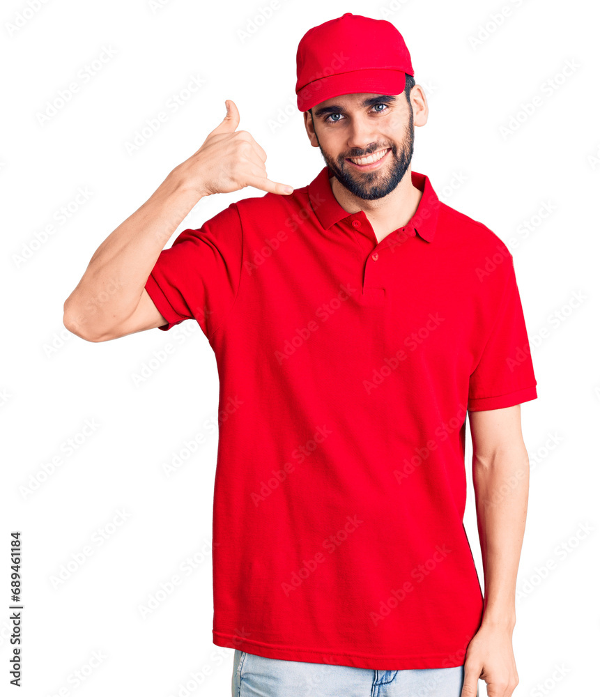 Young handsome man with beard wearing delivery uniform smiling doing phone gesture with hand and fingers like talking on the telephone. communicating concepts. Young handsome man with beard wearing delivery uniform smiling doing phone gesture with hand and fingers like talking on the telephone. communicating concepts.