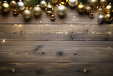 Christmas tree branches with baubles and lights against wooden planks