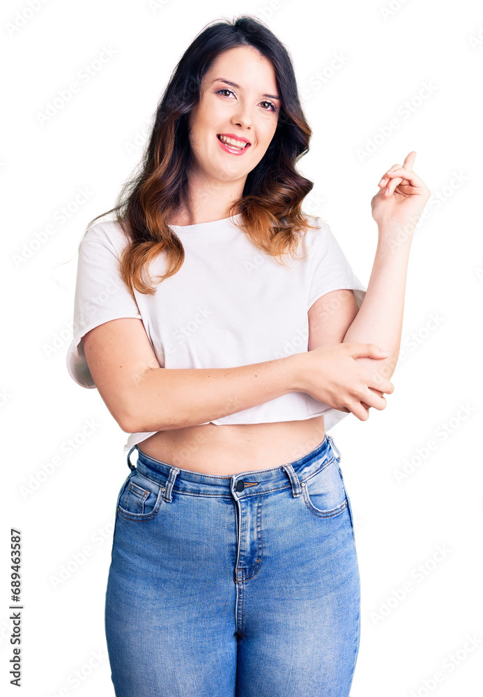 Beautiful young brunette woman wearing casual clothes smiling happy pointing with hand and finger to the side Beautiful young brunette woman wearing casual clothes smiling happy pointing with hand and finger to the side