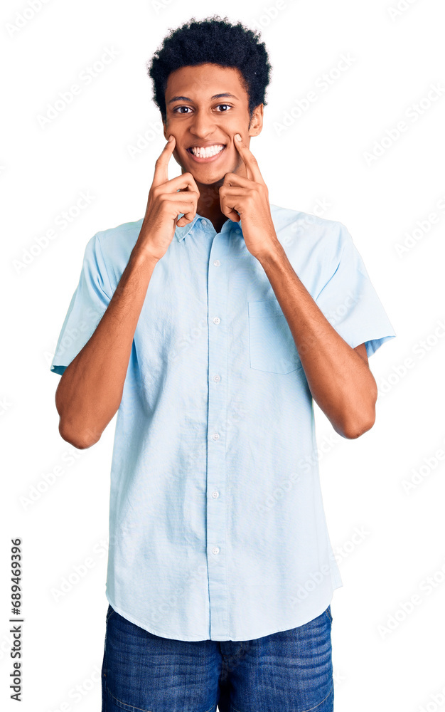 Young african american man wearing casual clothes smiling with open mouth, fingers pointing and forcing cheerful smile