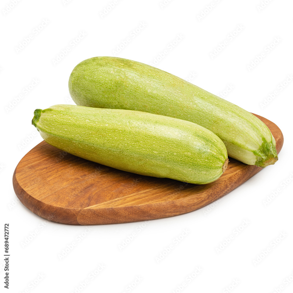 Fresh zucchini on a wooden board, on a white background, isolate Fresh zucchini on a wooden board, on a white background, isolate