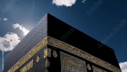Close up of Haram Mosque minaret in a cloudy day. Holy Kaaba Animation With Heaven Atmosphere Effect. Kaaba in Masjid Al Haram in Mecca Saudi Arabia. Muslim Pilgrims Offer Prayers. Islamic Background. photo