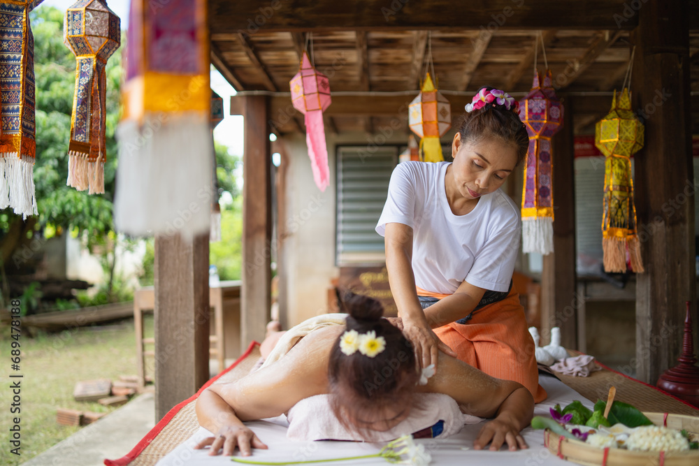 Massage and spa relaxing treatment of office syndrome traditional thai massage style. Asain female masseuse doing massage and skin scrub treat back pain, arm pain and stress for good skin and health. - obrazy, fototapety, plakaty 