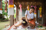 Massage and spa relaxing treatment of office syndrome traditional thai massage style. Asain female masseuse doing massage and skin scrub treat back pain, arm pain and stress for good skin and health.