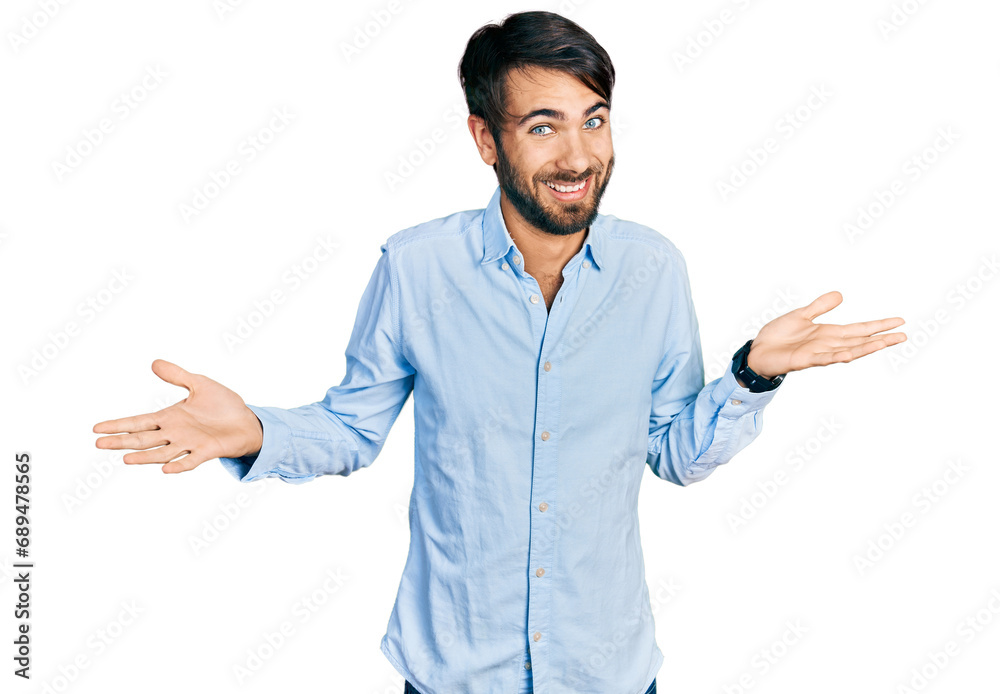 Hispanic man with blue eyes wearing business shirt smiling showing both hands open palms, presenting and advertising comparison and balance Hispanic man with blue eyes wearing business shirt smiling showing both hands open palms, presenting and advertising comparison and balance