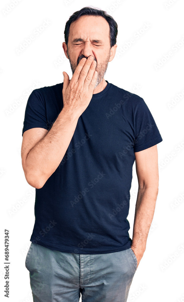 Middle age handsome man wearing casual t-shirt bored yawning tired covering mouth with hand. restless and sleepiness. Middle age handsome man wearing casual t-shirt bored yawning tired covering mouth with hand. restless and sleepiness.