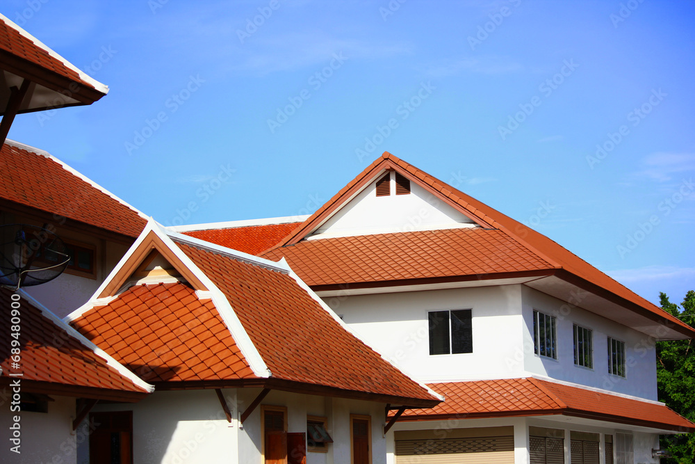 Thai resident using roof tiles goemetric shape exterior design retroThai style against blue sky