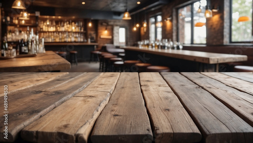 Empty wooden table and blurred background of a bar or pub. For displaying products.
