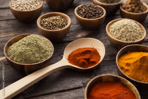 Spices and herbs in wooden bowls and spoons. Food and cooking ingredients.