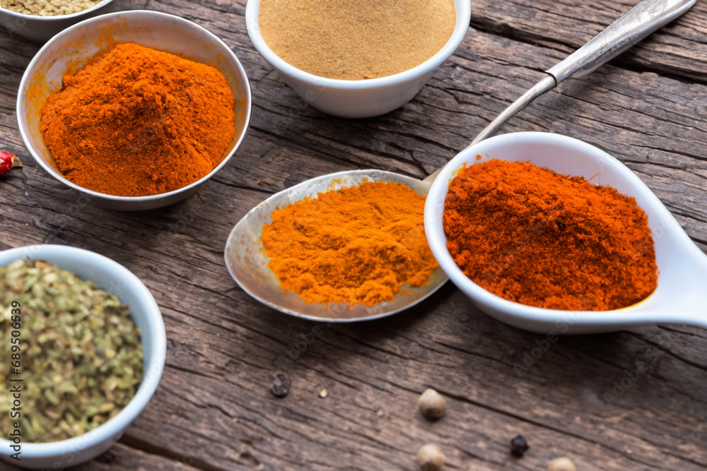 Spices and herbs in wooden bowls and spoons. Food and cooking ingredients. Spices and herbs in wooden bowls and spoons. Food and cooking ingredients.