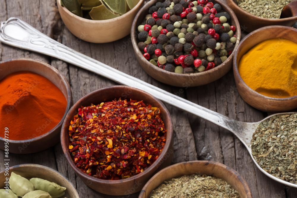 Spices and herbs in wooden bowls and spoons. Food and cooking ingredients.