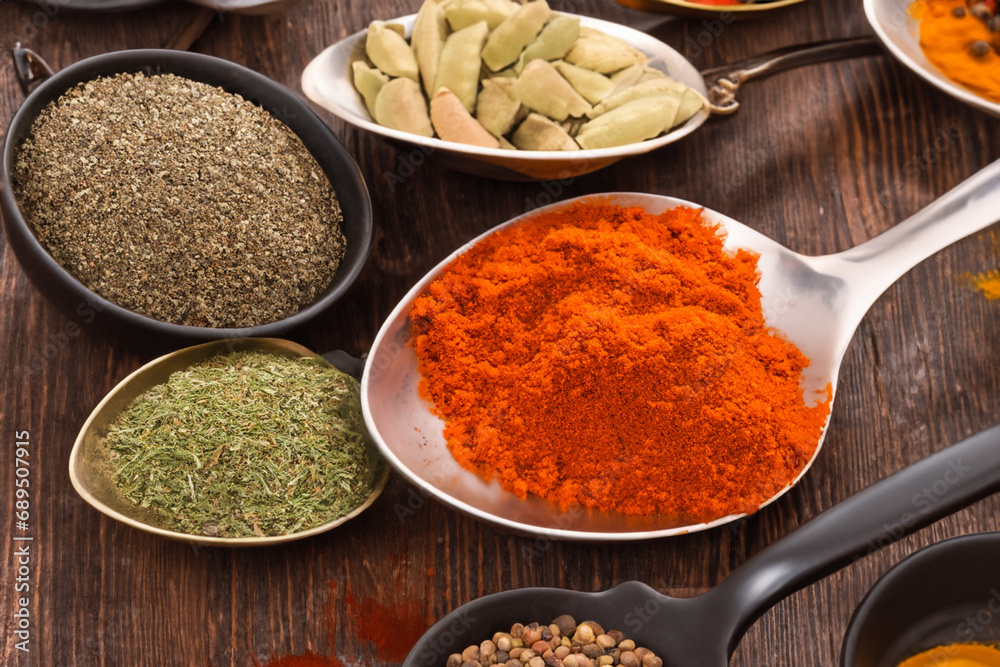 Spices and herbs in wooden bowls and spoons. Food and cooking ingredients.