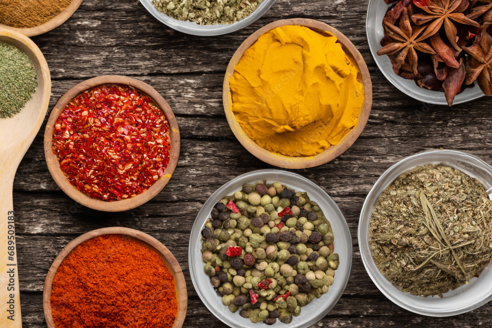 Spices and herbs in wooden bowls. Food and cuisine ingredients. Spices and herbs in wooden bowls. Food and cuisine ingredients.