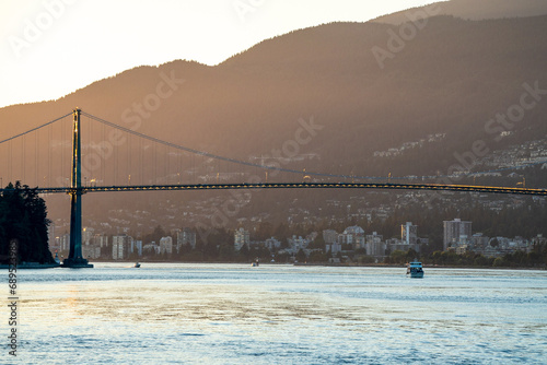Suspension Bridge Silhouette at Sunset Over Calm Waters