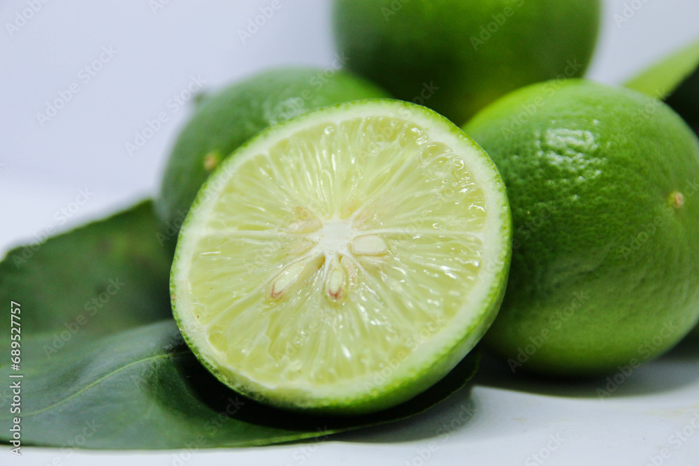 The green lime, a citrus marvel, presents a captivating sight in nature's palette. Its vibrant hue, a symphony of emerald and jade, immediately commands attention. The lime's exterior is a textured ca The green lime, a citrus marvel, presents a captivating sight in nature's palette. Its vibrant hue, a symphony of emerald and jade, immediately commands attention. The lime's exterior is a textured ca
