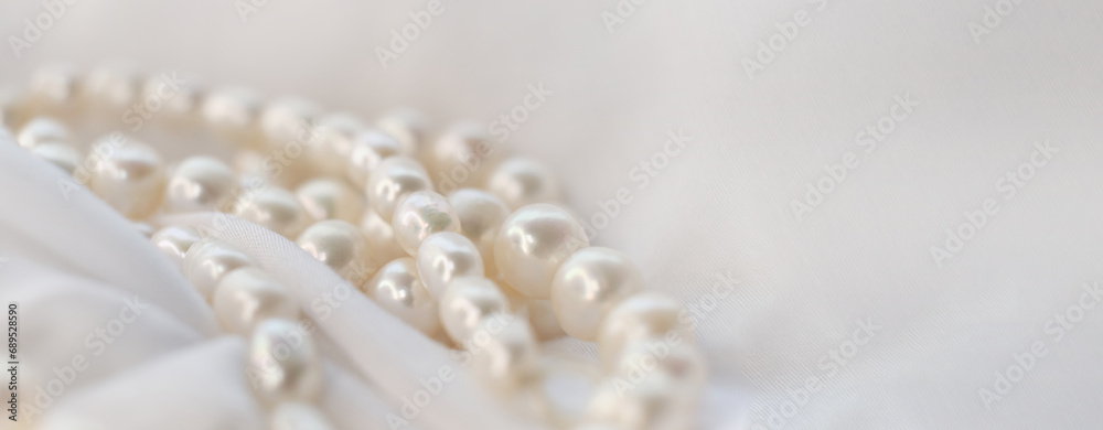 The soft focus on the pearls exudes a gentle, soothing aura on a pristine white fabric. It subtly champions the cause of natural beauty in a world obsessed with manufactured perfection. The soft focus on the pearls exudes a gentle, soothing aura on a pristine white fabric. It subtly champions the cause of natural beauty in a world obsessed with manufactured perfection.