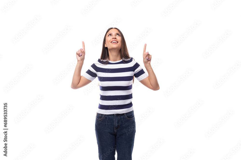 cute young european woman with black straight hair dressed in a striped black and white t-shirt points her hands up at the empty space cute young european woman with black straight hair dressed in a striped black and white t-shirt points her hands up at the empty space