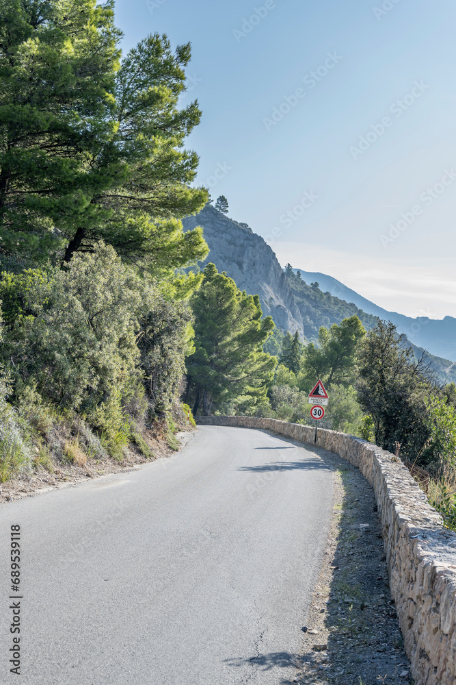 mountain road on steep slope at Mediterranean shore, Monte Argentario, Italy