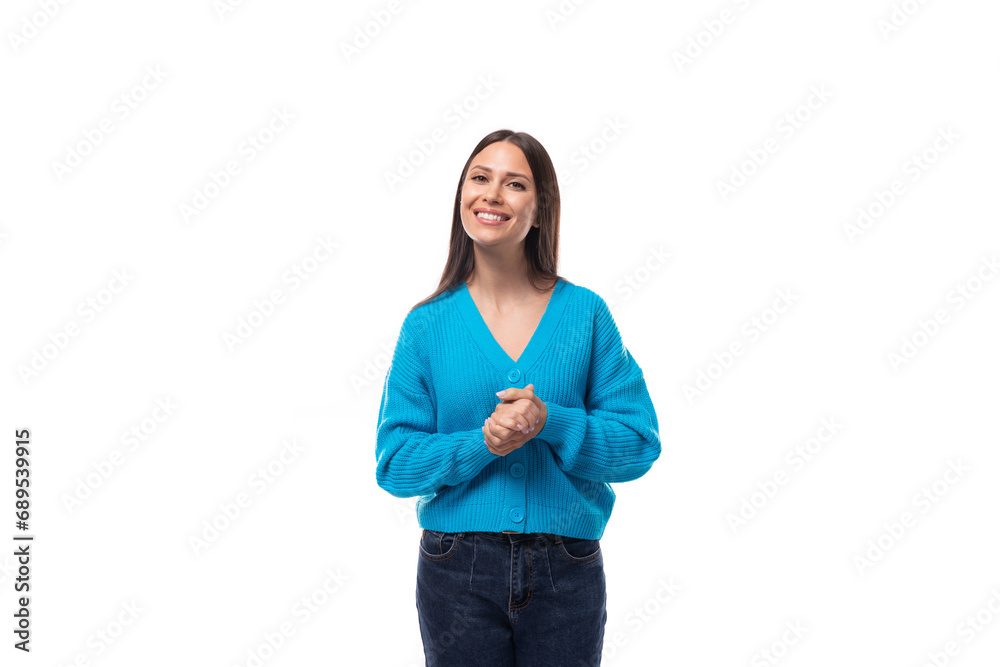 charming caucasian woman with black hair is dressed in a blue sweater on a white background. people lightstyle concept charming caucasian woman with black hair is dressed in a blue sweater on a white background. people lightstyle concept
