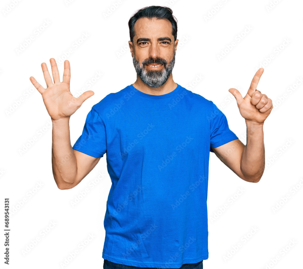 Fototapeta premium Middle aged man with beard wearing casual blue t shirt showing and pointing up with fingers number seven while smiling confident and happy.