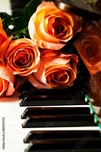 Bouquet of pink roses on the piano keyboard, romantic atmosphere. A gift from fans.
