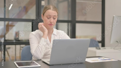 Mature Business Woman having Neck Pain at Work photo