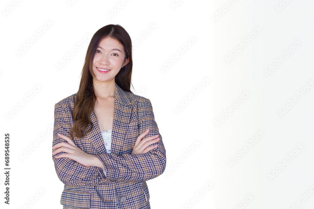 Adult Asian professional woman with black long hair wearing plaid suit stand with arms crossed and pretty smiling looking at camera is present product on white background. Adult Asian professional woman with black long hair wearing plaid suit stand with arms crossed and pretty smiling looking at camera is present product on white background.