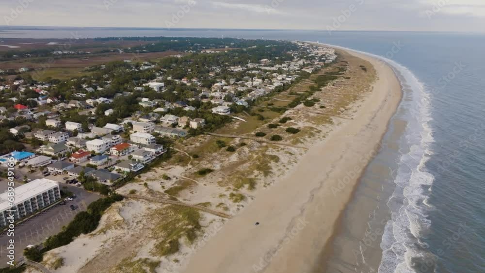 Drone of an empty beach in Tybee Island approaching vacation homes and residential areas Drone of an empty beach in Tybee Island approaching vacation homes and residential areas