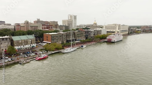 Drone of Savannah Georgia riverfront area along the river approaching boats on an overcast day photo