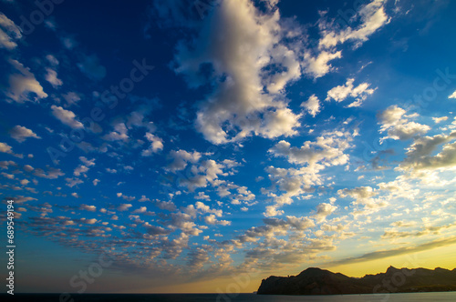 Real amazing panoramic sunrise or sunset sky with gentle colorful clouds.