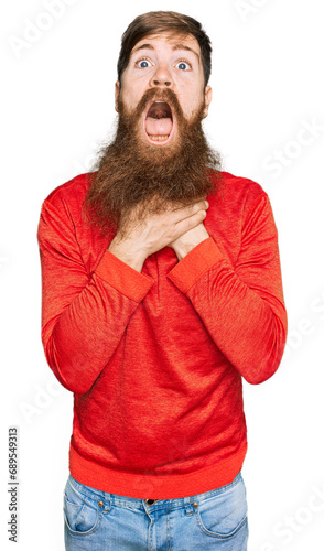 Redhead man with long beard wearing casual clothes shouting and suffocate because painful strangle. health problem. asphyxiate and suicide concept.