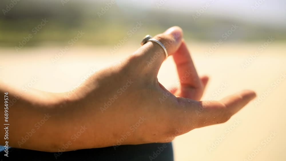 Hands, beach and closeup of woman doing a meditation exercise for zen, health and wellness. Calm, spiritual and zoom of female person in yoga pose for mind, body and chakra balance by the ocean.