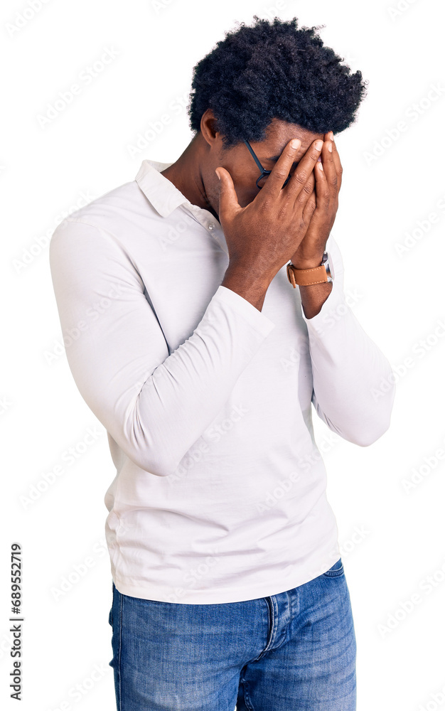 Handsome african american man with afro hair wearing casual clothes and glasses with sad expression covering face with hands while crying. depression concept. Handsome african american man with afro hair wearing casual clothes and glasses with sad expression covering face with hands while crying. depression concept.