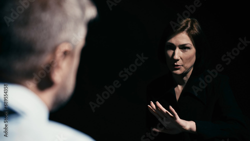 A woman in custody is denying involvement in the illegal drug trade during police interrogation photo