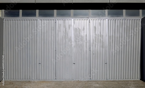 Three large corrugated metal doors  one close to each other   in an industrial building