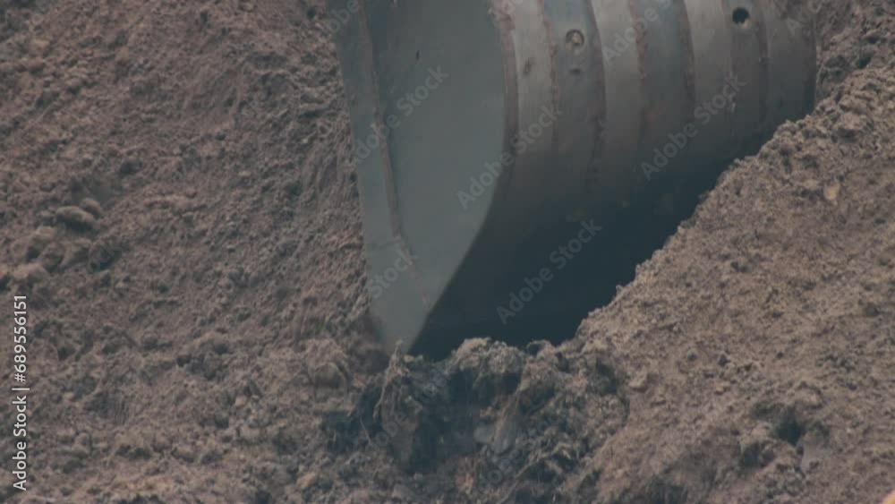 Rotary and telescopic excavator bucket picks up soil for pipeline replacement Rotary and telescopic excavator bucket picks up soil for pipeline replacement