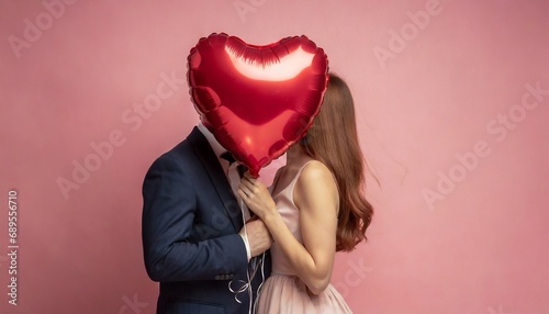 Couple kissing behind a Balloon
