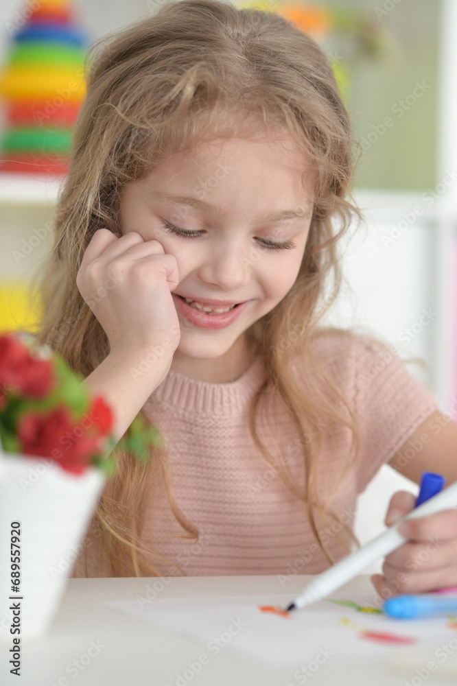 cute girl in the nursery draws at the table cute girl in the nursery draws at the table
