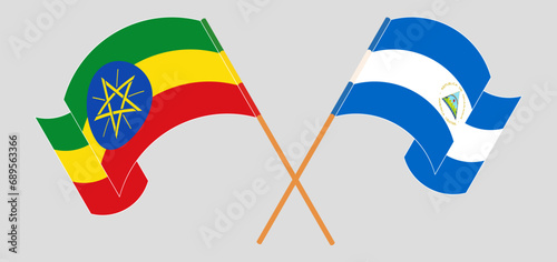 Crossed and waving flags of Ethiopia and Nicaragua