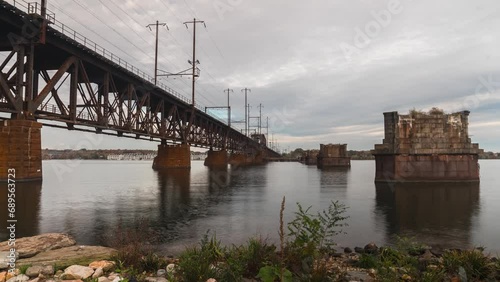 Timelapse of storm clouds passing through, trains zooming by and boats cruising in the water photo