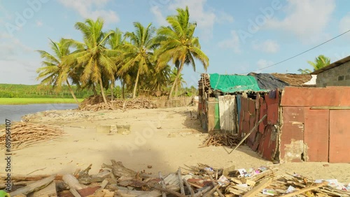 established shot of Moree ghana africa traditional fisherman village with ocean sea beach and palm tree  photo