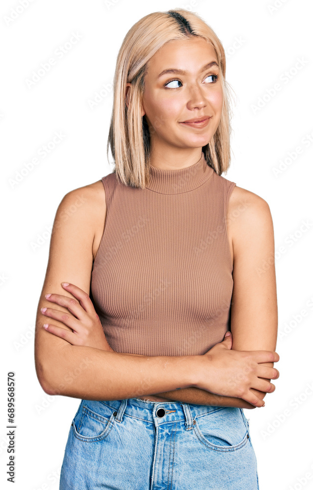 Beautiful young blonde woman wearing casual style with sleeveless shirt smiling looking to the side and staring away thinking. Beautiful young blonde woman wearing casual style with sleeveless shirt smiling looking to the side and staring away thinking.