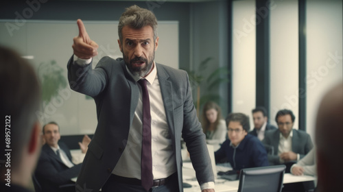 Man manager wearing a suit get angry in office meeting room pointing out to coworkers and setting up a bad unhealthy ambiance at work