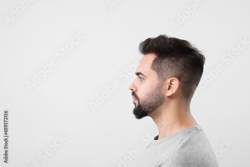 Man with healthy hair on light grey background, space for text