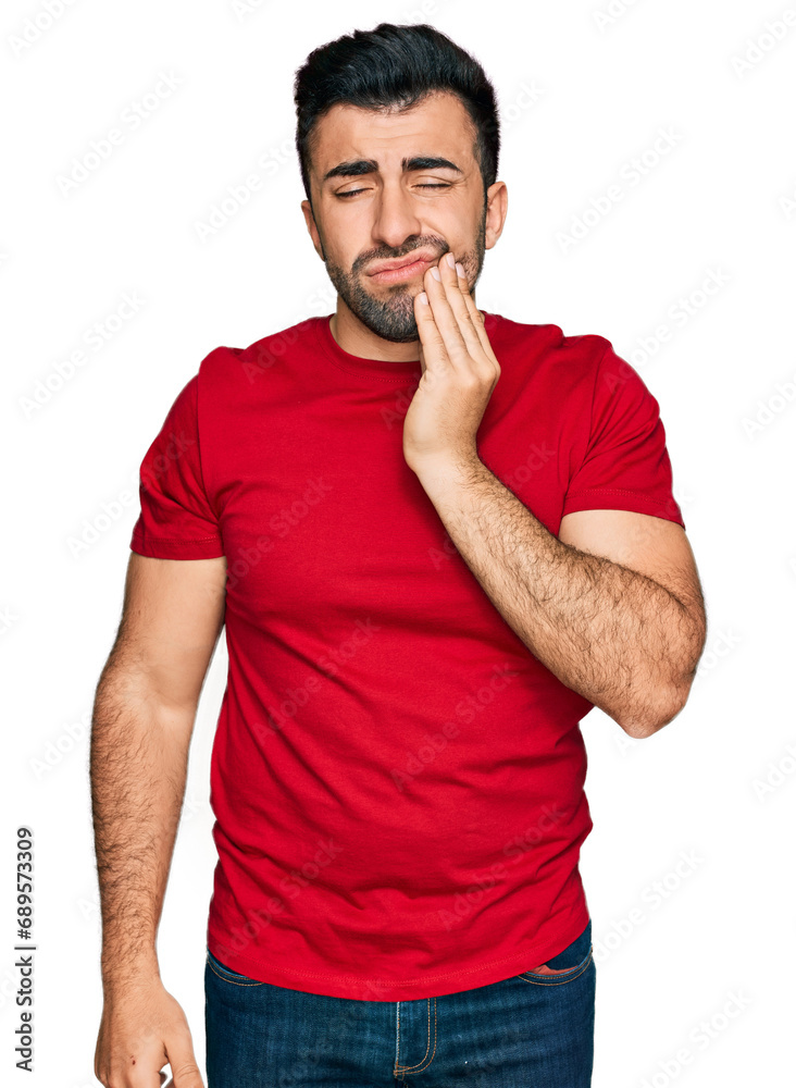 Hispanic man with beard wearing casual red t shirt touching mouth with hand with painful expression because of toothache or dental illness on teeth. dentist Hispanic man with beard wearing casual red t shirt touching mouth with hand with painful expression because of toothache or dental illness on teeth. dentist