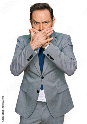 Middle age man wearing business clothes shocked covering mouth with hands for mistake. secret concept.